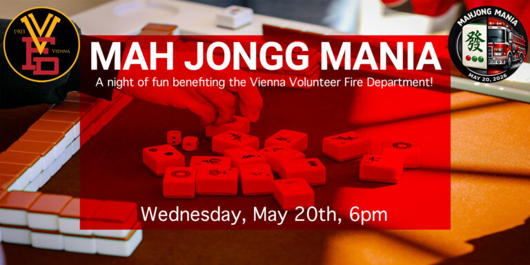 A close-up of hands playing mahjong with red and white tiles on a table. Text promotes "Mah Jongg Mania," a fundraising event for the Vienna Volunteer Fire Department on Wednesday, May 20th, 6pm.